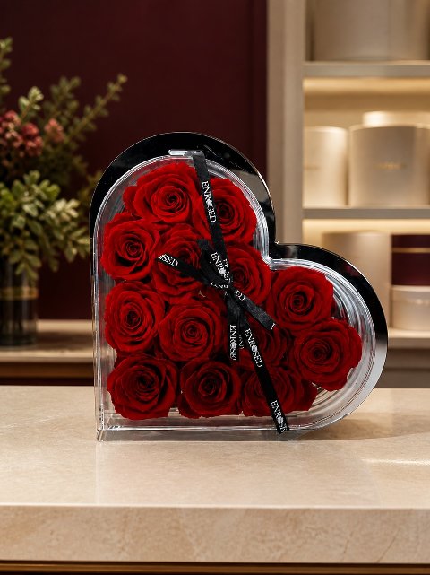 Heart-shaped clear flowerbox with red preserved roses — in the Enrosed showroom